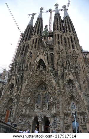 BARCELONA, SPAIN - SEPTEMBER 17, 2013: Works in progress on the facade of La Sagrada Familia - the famous church designed by Antonio Gaudi. It is anticipated that the works will be completed in 2026.