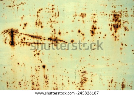 Yellow-green metal surface/texture/background covered with rust. Retro/vintage style.