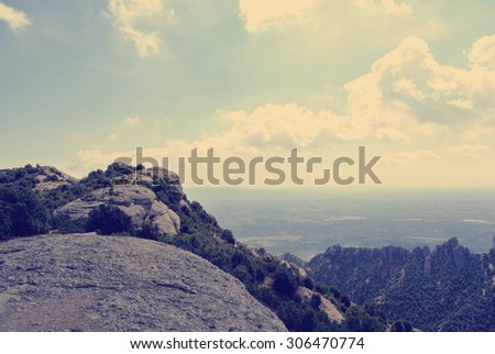 Panoramic view on the rugged landscape of the Montserrat mountain, located close to Barcelona. Image filtered in faded, washed out, retro, Instagram style; nostalgic vintage travel concept.