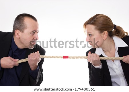 Man and woman pulling a rope against each other