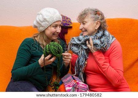 Mother and daughter knitting together