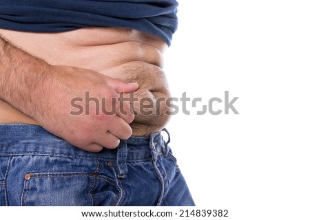 A caucasian man grabs his far hairy belly