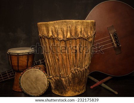 Old music instruments - Djembe drums and acoustic bass guitar