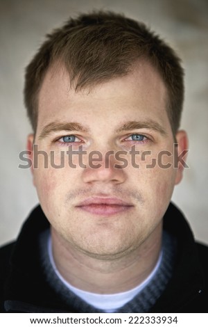 Portrait of young man with blue eyes.