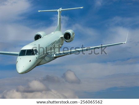 Private jet isolated on blue cloudy sky