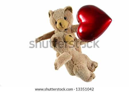 two teddybears with red heart as symbol for love on white background as one of my isolated objects