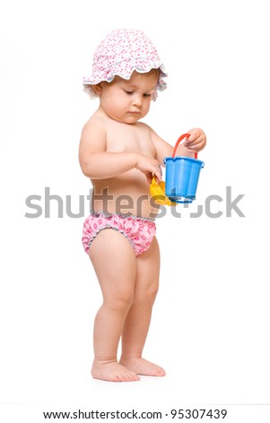Cute baby in swimming pants and sunhat playing, isolated over white