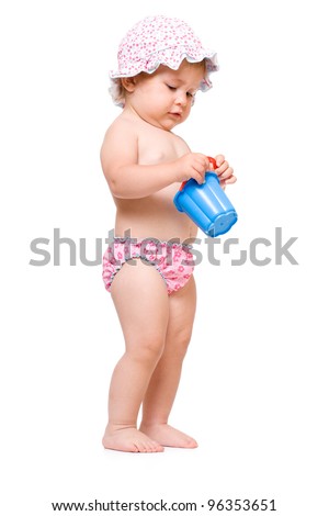 Cute baby girl in swimming pants and sunhat playing, isolated over white background