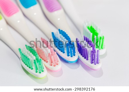 Five multicolored toothbrushes on white background / Toothbrushes