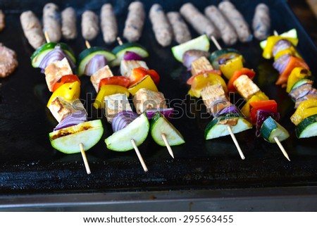 Grilling vegetables and vegan, vegetarian skewers or kebabs with tofu, onions, pumpkins and peppers.