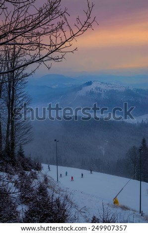 Fantastic foggy winter landscape with sun reflection. Carpathian, Ukraine