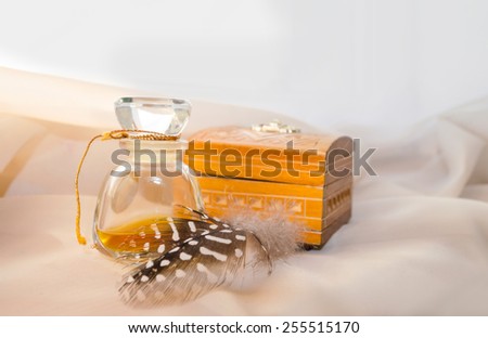 Vintage Perfume Bottle with wooden casket and feather