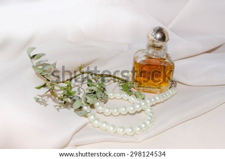 Vintage Perfume Bottle with dry rose branch and pearls