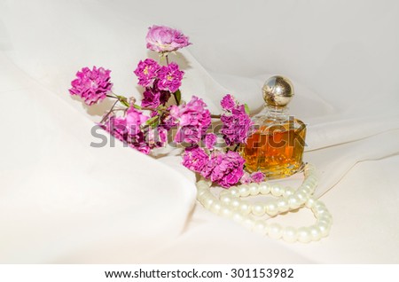 Vintage Perfume Bottle with dry roses and pearls