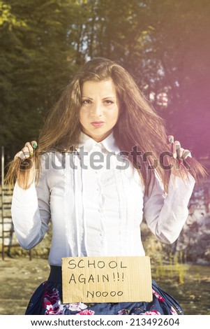 Girl pulls the hair and holding a paper with the inscription not in school