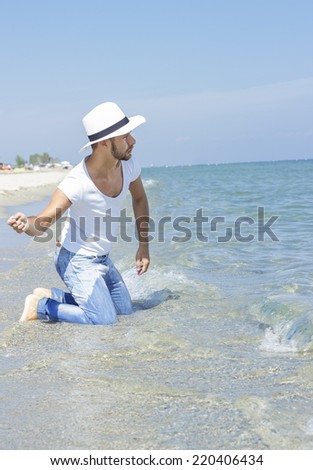 Boy has fun throwing stones at the beach