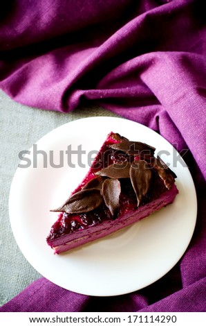 piece of purple cake souffle black currants on a  purple background