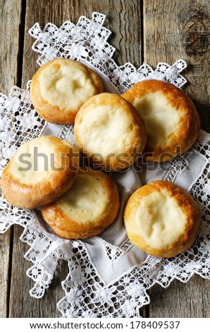 patties with cottage cheese, vatrushka on a wood background