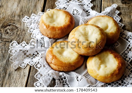 patties with cottage cheese, vatrushka on a wood background