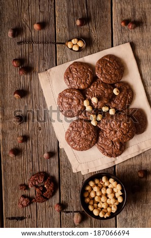 chocolate chip cookies with walnuts on a wood background. toning