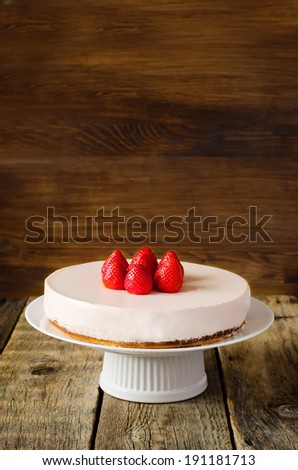 cheesecake with strawberry on a dark wood background. selective focus on strawberries.  toning
