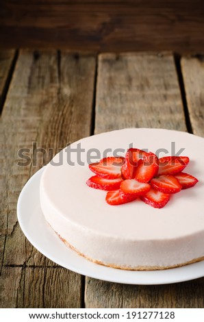 cheesecake with strawberry on a dark wood background. selective focus on strawberries. toning