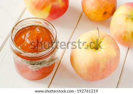 Apple jam on a white wood background. toning. selective focus on the jam