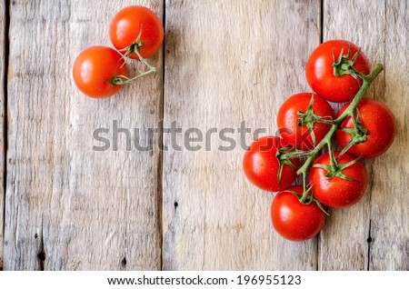 red cherry tomatoes on a white wood background. toning. selective focus on the right tomato