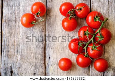 red cherry tomatoes on a white wood background. toning. selective focus on the right tomatoes