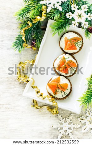 canape with salmon and cream cheese on a light background. tinting. selective focus on the middle canape