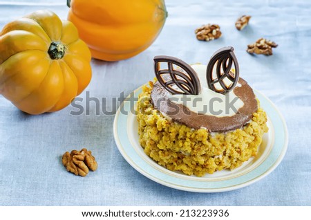 pumpkin cheesecake with chocolate and walnuts on a light blue background. tinting. selective focus on the middle of the cake