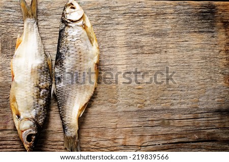 fish vobla on a dark wood background. tinting. selective focus on the right fish