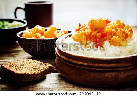 rice with curry cauliflower on a dark wood background. tinting. selective focus on the middle of the rice
