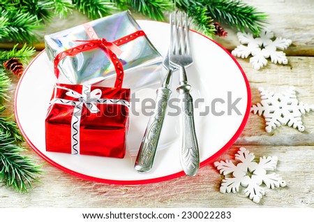 Christmas background with gifts on plate on a light woody background. tinting. selective focus on gift