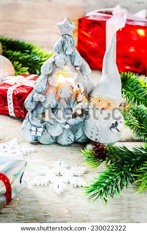 Christmas background with gifts, Santa Claus and balls on a light woody background. tinting. selective focus on Santa Claus