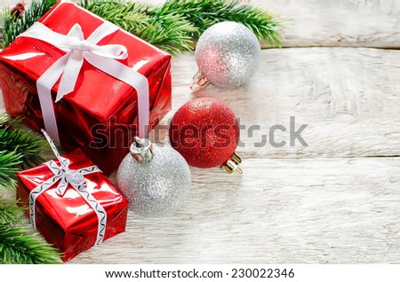 Christmas background with gifts and balls on a light woody background. tinting. selective focus on ball