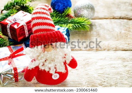 Christmas background with gifts, Santa Claus and balls on a light woody background. tinting. selective focus on Santa Claus