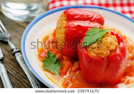 pepper stuffed with meat and rice on a dark wood background. tinting. selective focus
