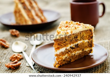 carrot cake with walnuts, prunes and dried apricots on a dark background. tinting. selective focus