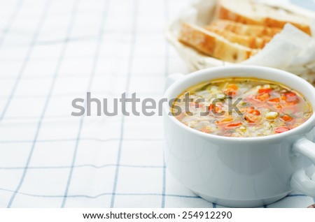 chicken soup with rice and peppers on a light background. tinting. selective focus