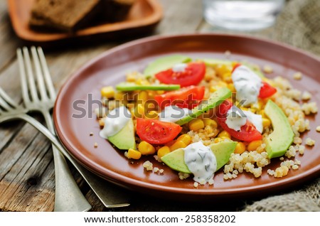 salad with quinoa, red lentils, corn, avocado and tomato with yogurt sauce. tinting. selective focus