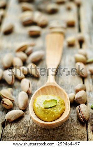 pistachio paste on a dark wood background. tinting. selective focus