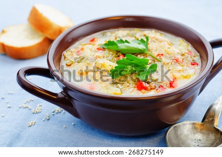 milk soup with potatoes, quinoa and peppers on a blue background. the toning. selective focus