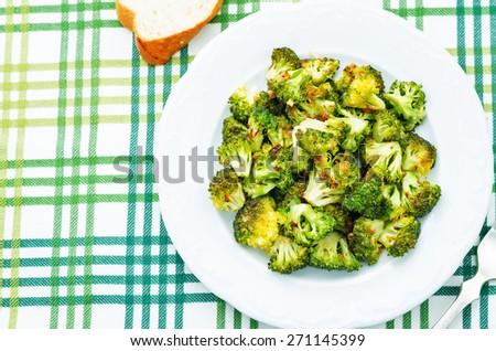roasted broccoli with garlic on a green background. the toning. selective focus