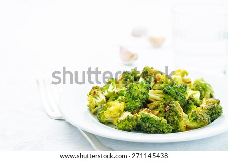roasted broccoli with garlic on a white background. the toning. selective focus