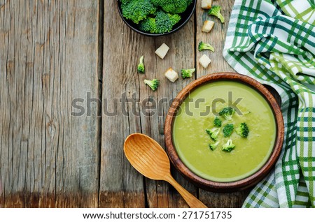 broccoli soup puree on a dark wood background. tinting. selective focus