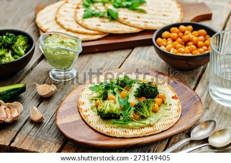 vegan tortilla with roasted broccoli and chickpeas and avocado sauce. the toning. selective focus
