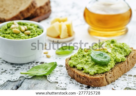 sandwich with spinach pesto on a white background. the toning. selective focus
