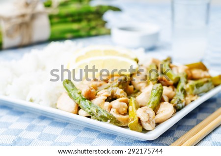 chicken asparagus lemon stir fry. the toning. selective focus