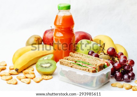 school lunch with a sandwich, fresh fruits, crackers and juice. the toning. selective focus